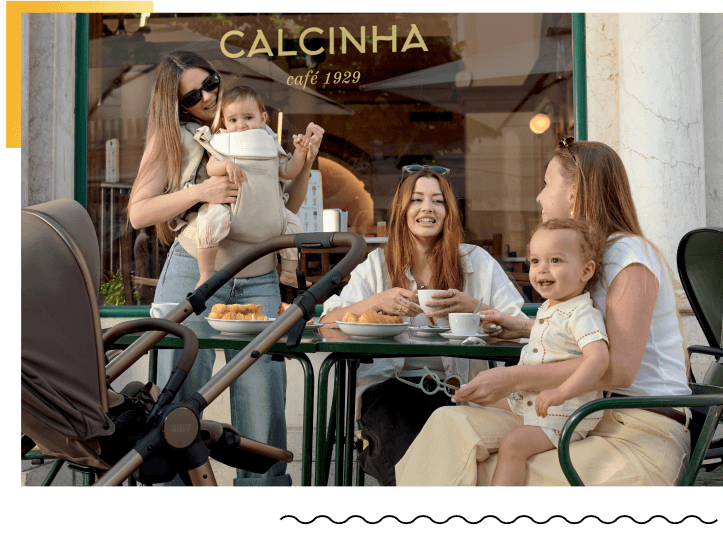Women and children enjoying coffee at an outdoor café.
