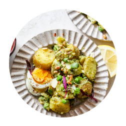 Gnocchi, potatoes and hardboiled eggs tossed in a pesto sauce served in a bowl
