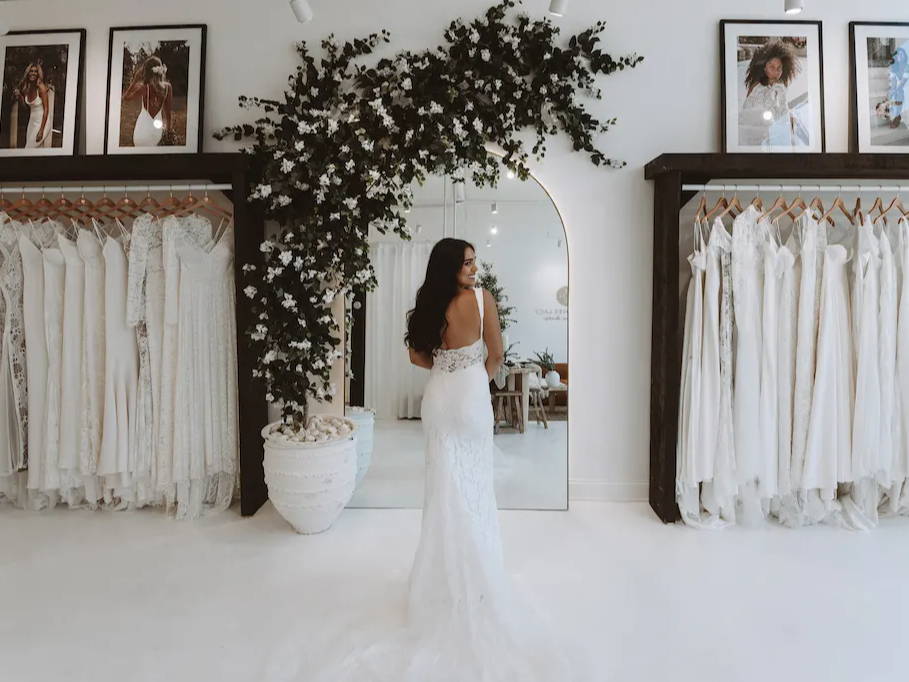 Bride wearing the Grace Loves Lace Lumi wedding dress in ivory with green and white florals