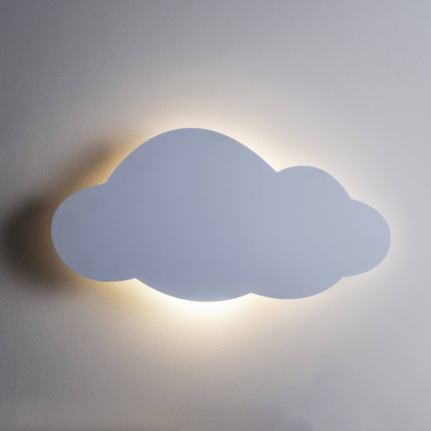 Cloud silhouette wall light illuminated on bedroom wall 