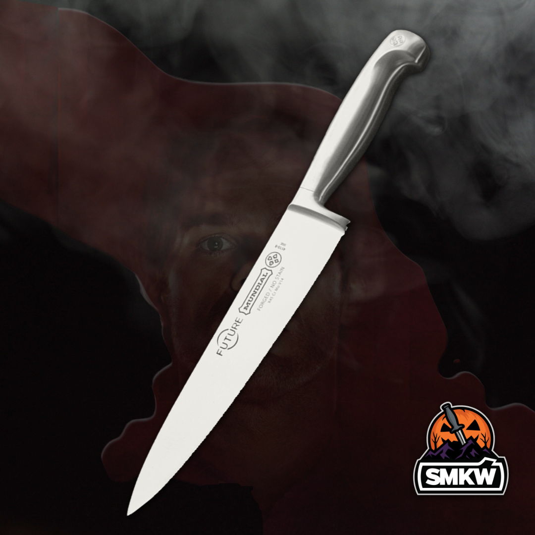 A sharp kitchen knife with a silver handle against a smoky background.