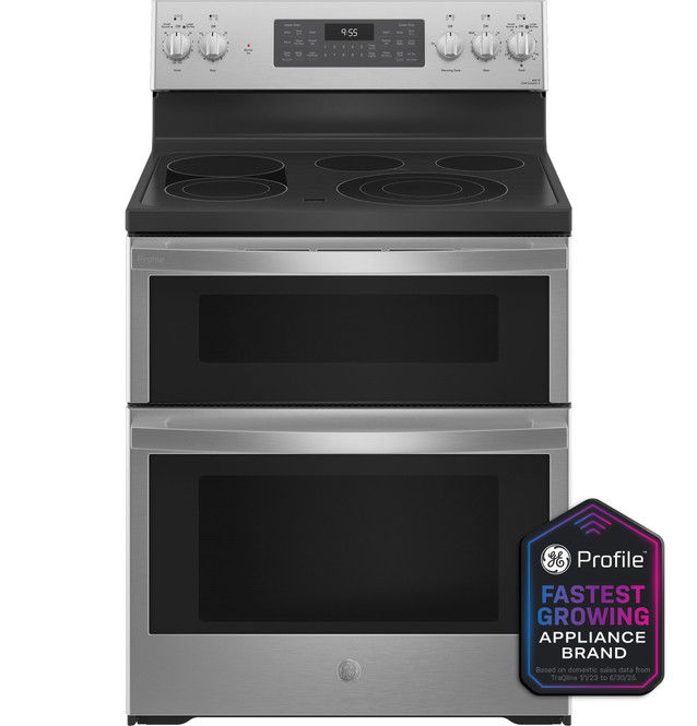 Stainless steel double oven range with four burners and control panel.