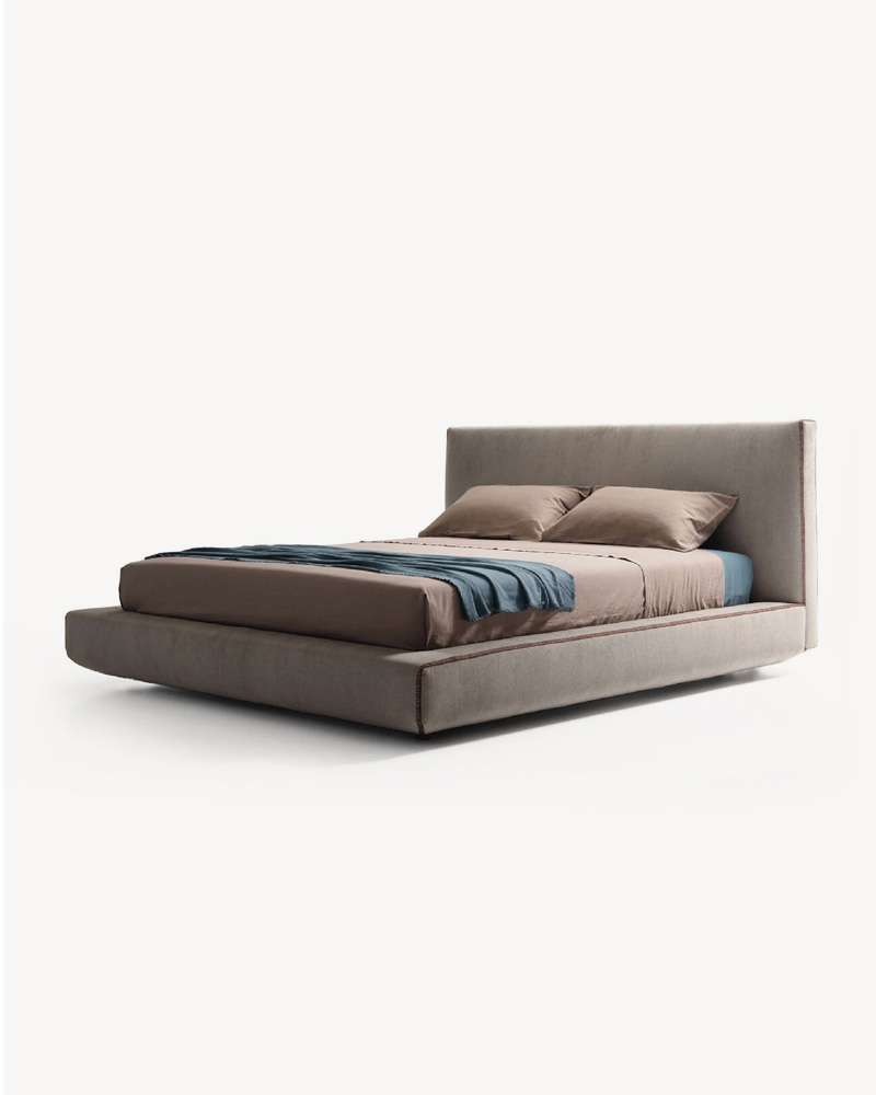 Modern Lema bed with a minimalist design, featuring a low profile and soft bedding.