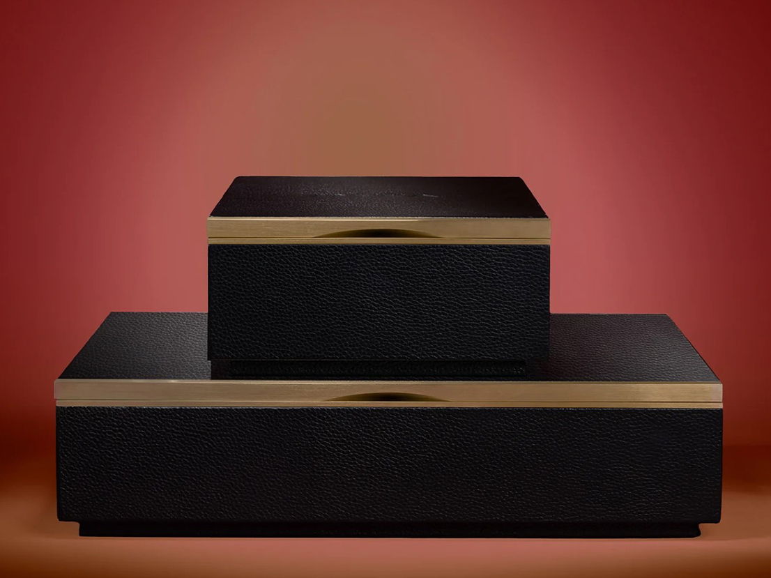 Two stacked black boxes with gold accents on a gradient background.