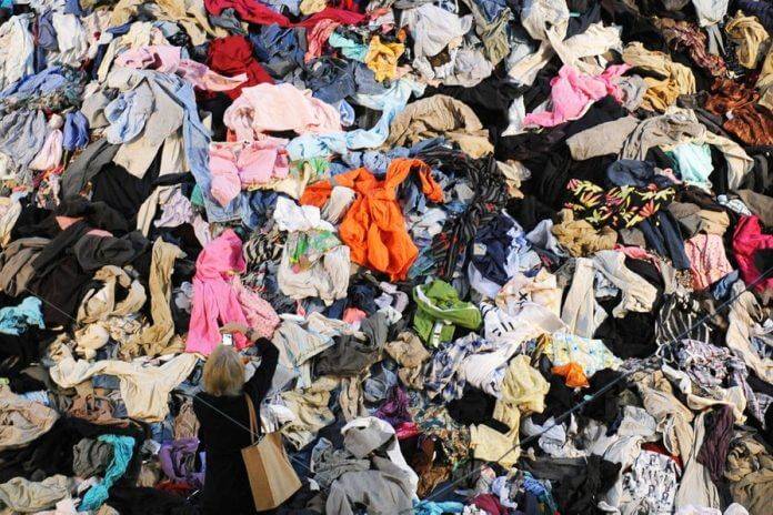 Dumpster pile of clothes made by fast-fashion companies