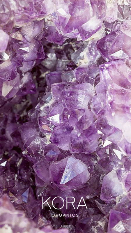 Amethyst crystal wallpaper with KORA Organics logo