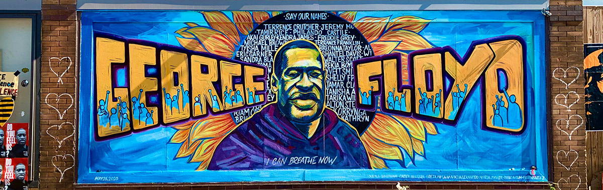 Mural of George Floyd with flowers at memorial where he was murdered