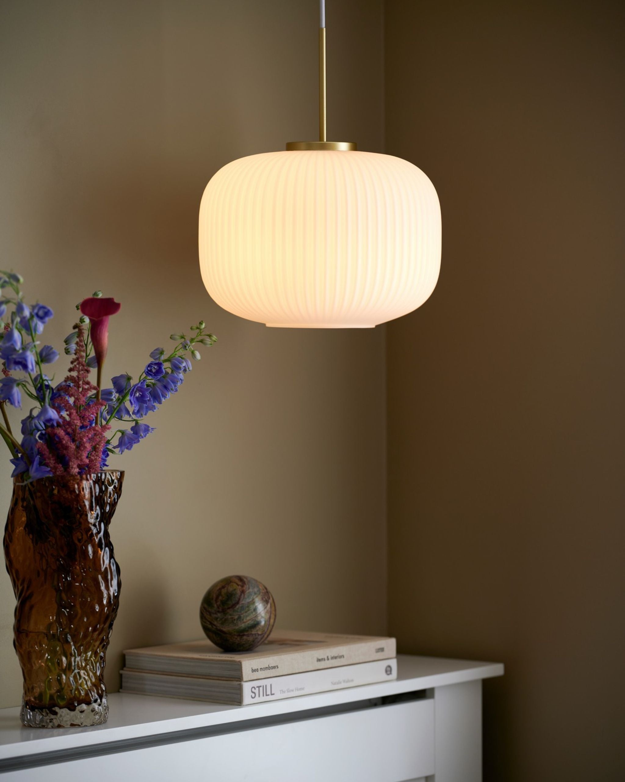 Scandinavian Decorative Glass Pendant with Brass Detailing suspended over a hallway console - Lighting Collective 