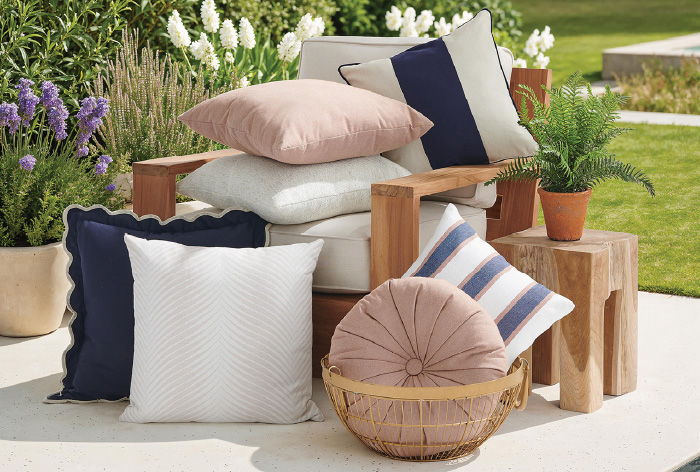 A cozy arrangement of decorative pillows on outdoor furniture.