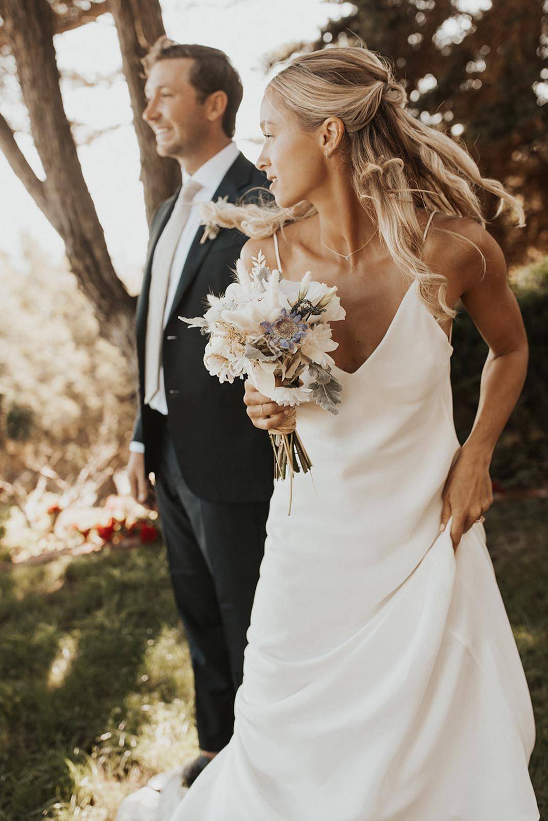 Bride holding white bouquet of flowers