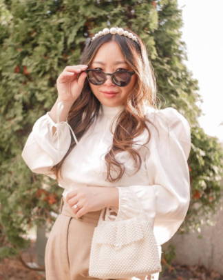 Woman wearing White Blouse, beige pants, pearl bag & hair band and Luxy Stylish Sunglasses