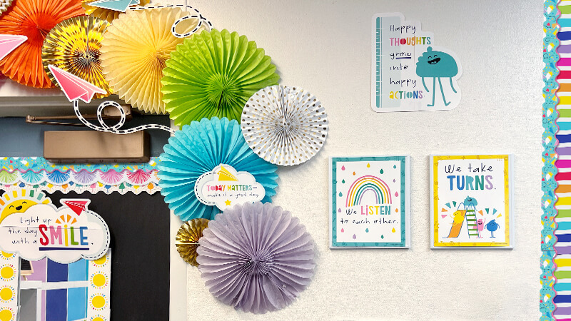Happy Place classroom decorations with colorful fans and motivational posters.