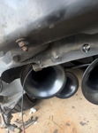 Detailed underside view of black Outlaw horn bells and mounting hardware on Jimmy's Volkswagen Beetle gallery photo 4