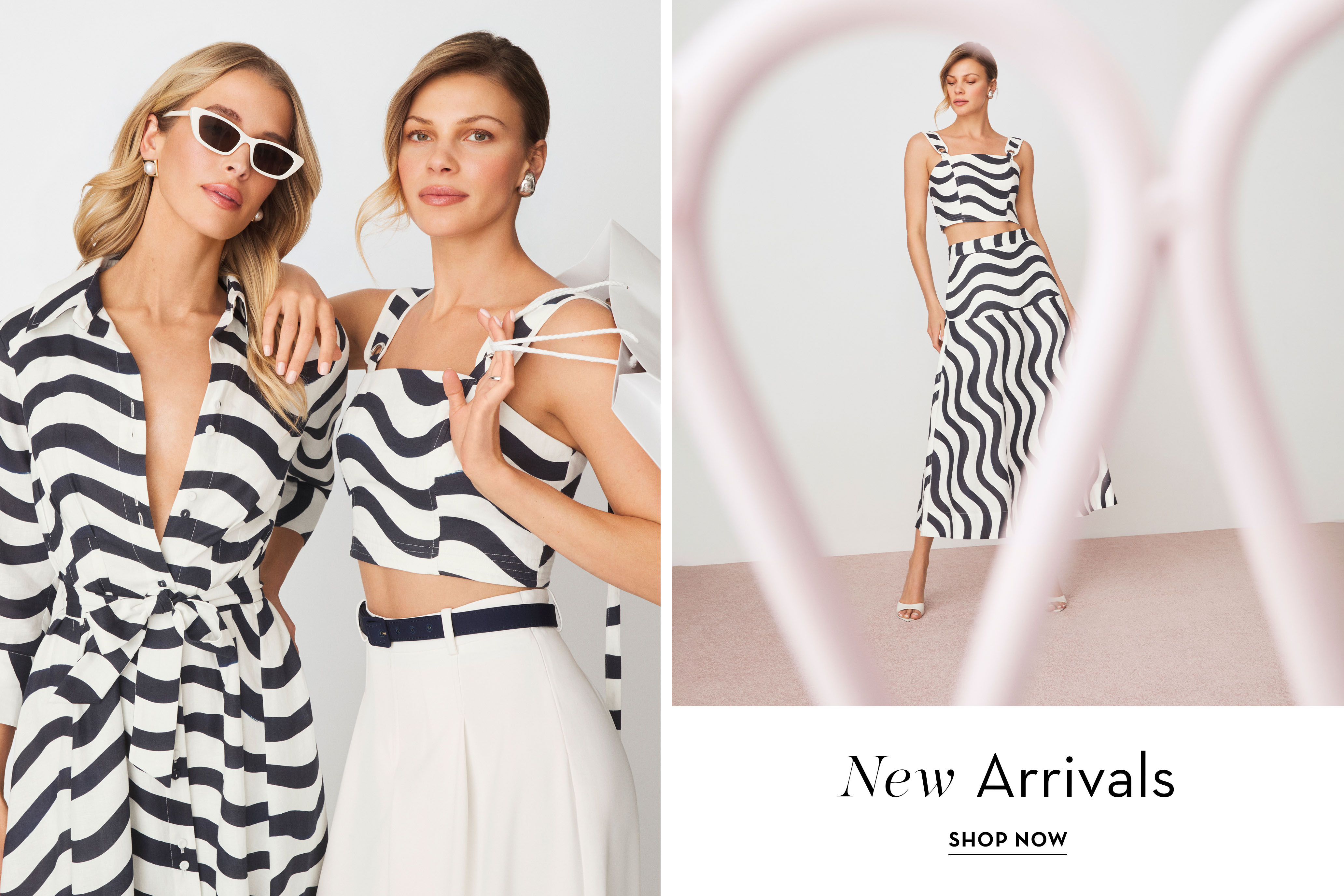 Two women modeling black and white striped outfits with a 
