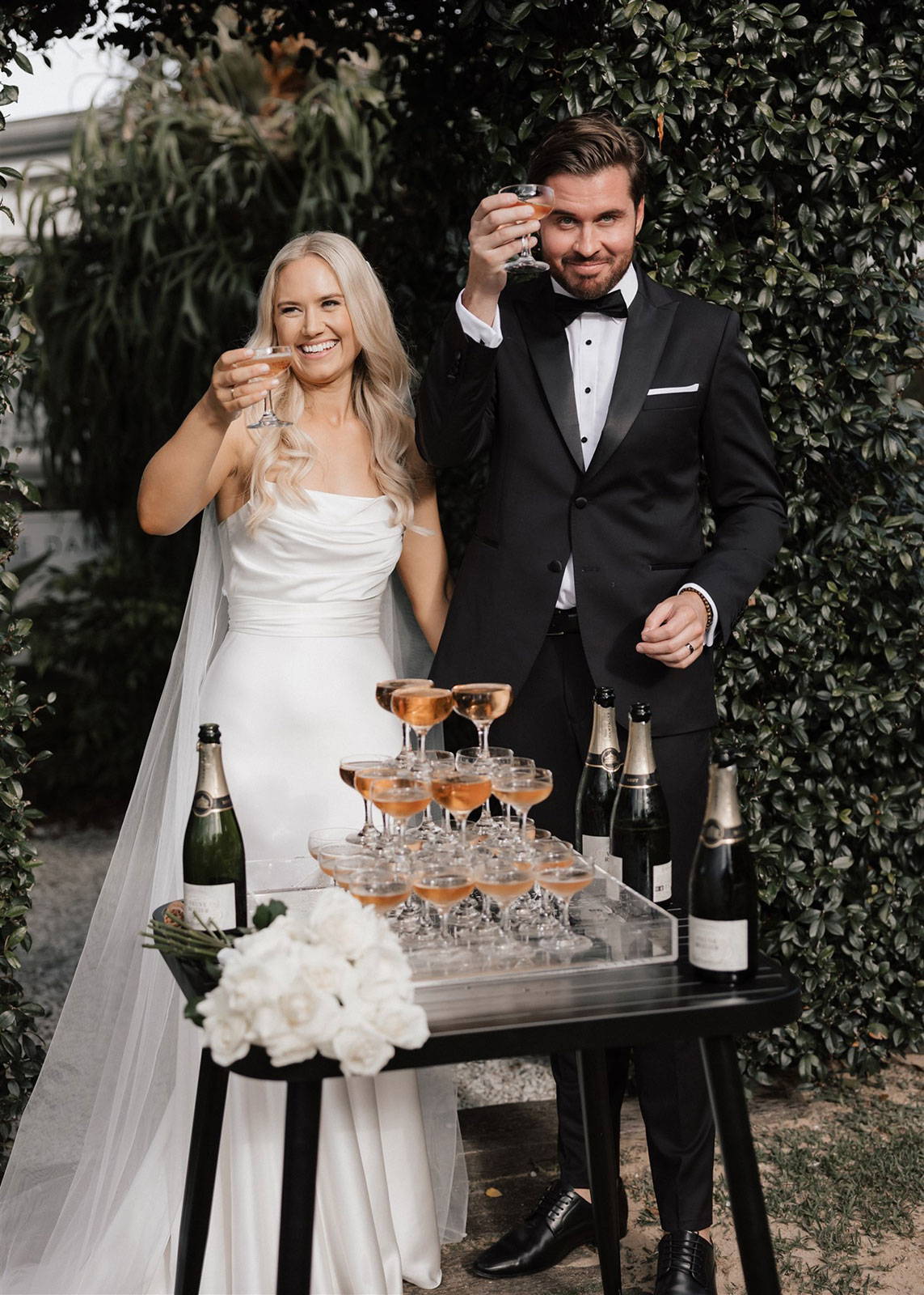 Bride and groom with prosecco tower