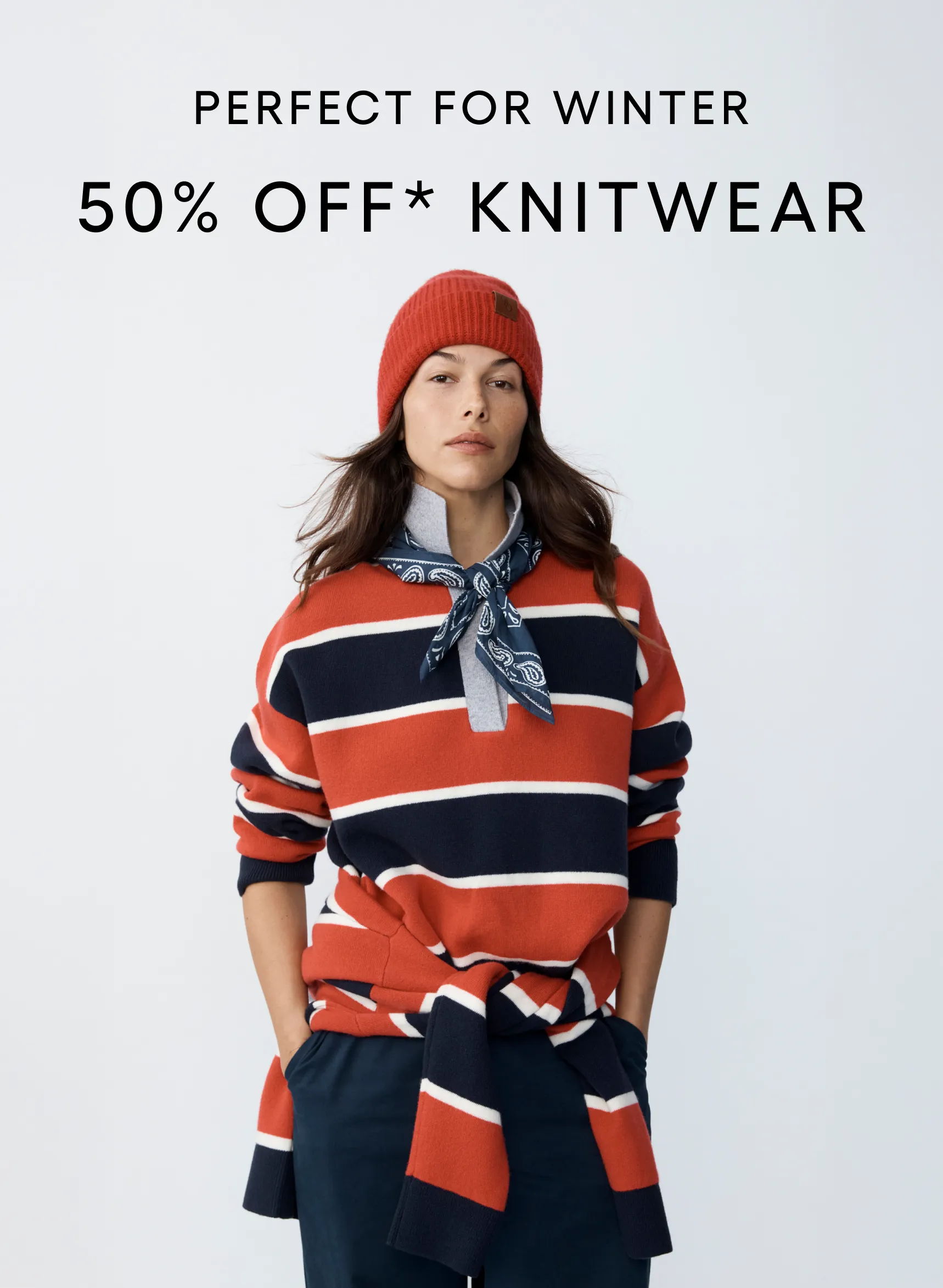Woman wearing striped knitwear with a red beanie, promoting a winter sale.