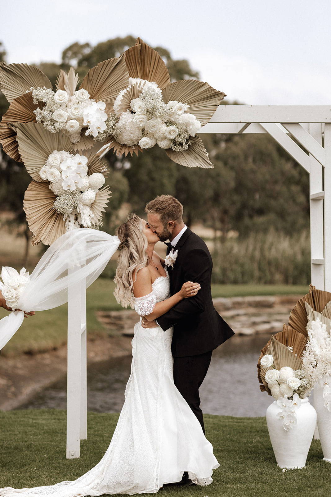 Bride and groom sharing a kiss at altar