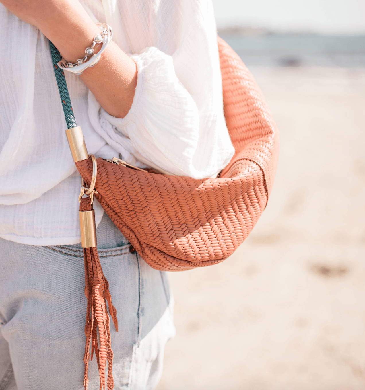 basketweave bag with tassel over a shoulder