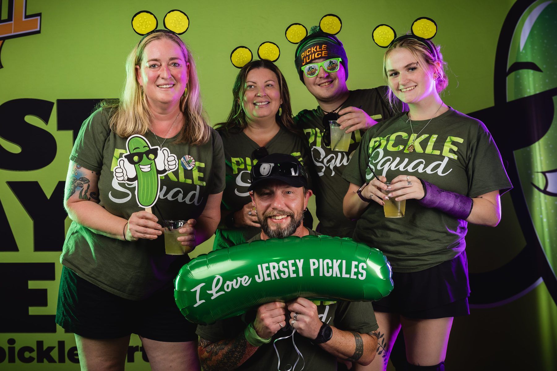 Pickle Squad members with a Jersey Pickles balloon and Pickle Juice merch at the photo booth at The Big Dill.