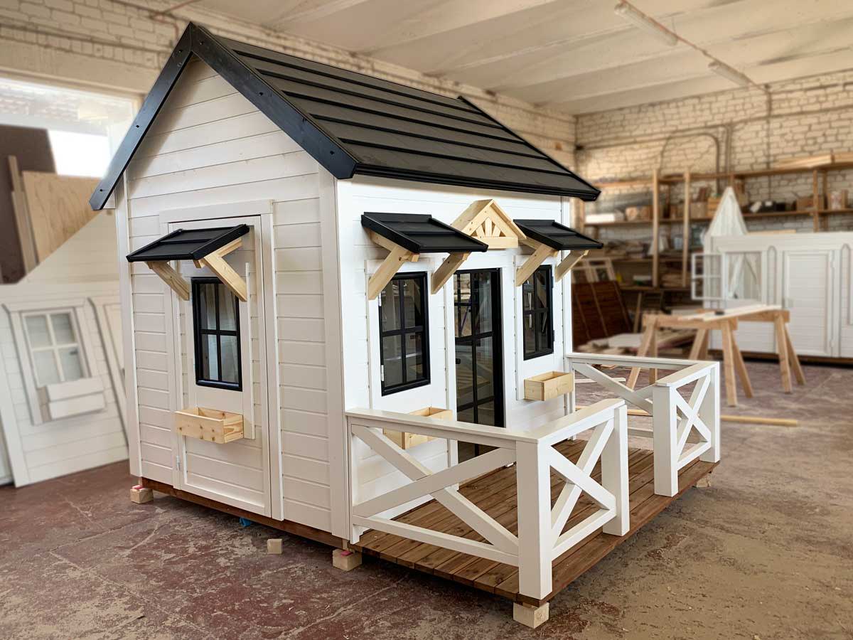 Wooden Playhouse with custom made glass door, terrace and little roofs by WholeWoodPlayhouses