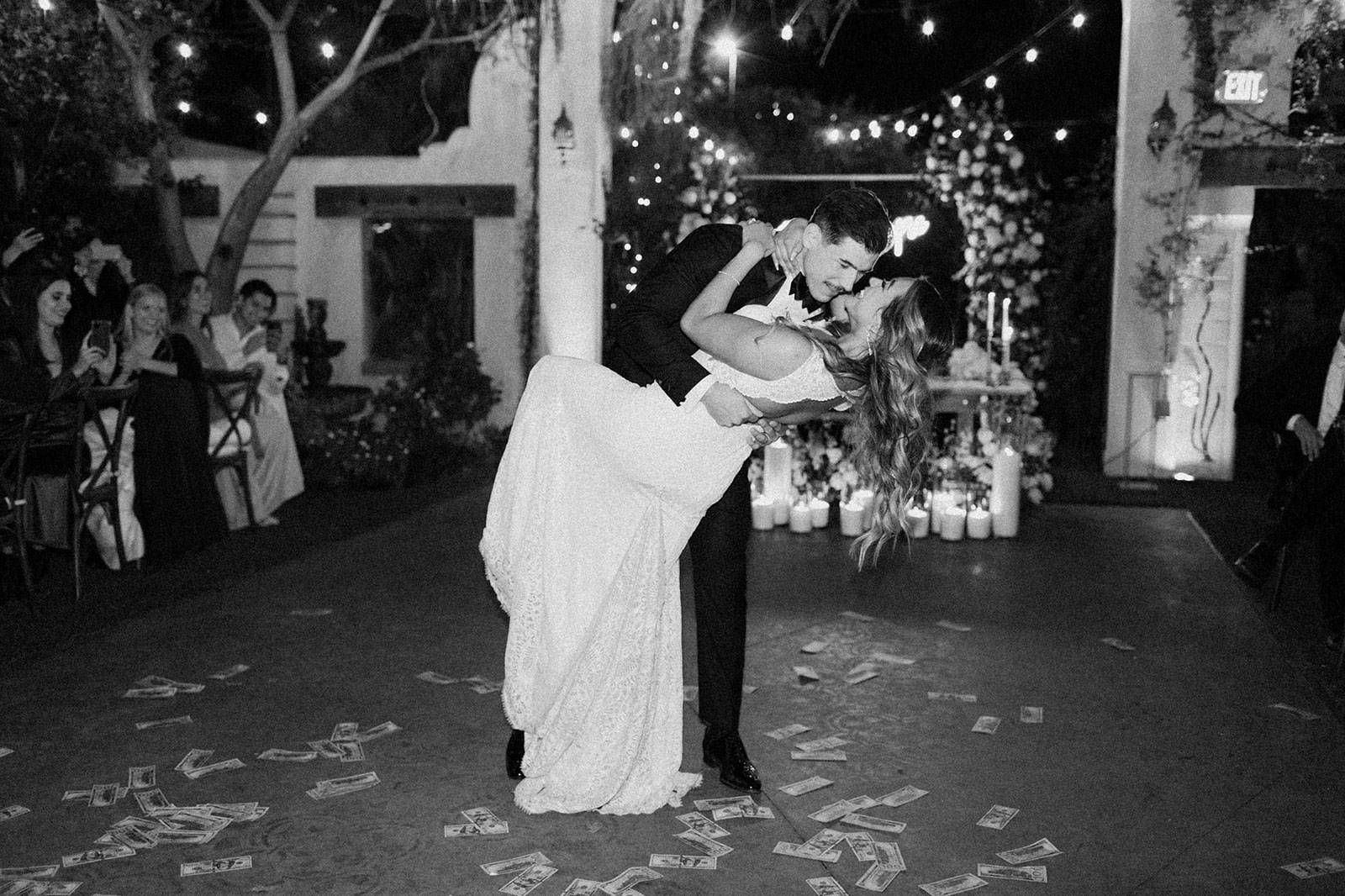 Groom dipping bride at their wedding reception