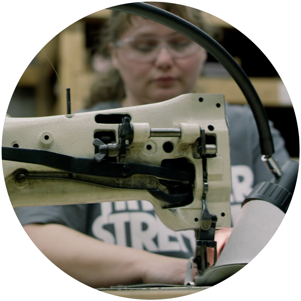 American worker sewing upholstery on equipment