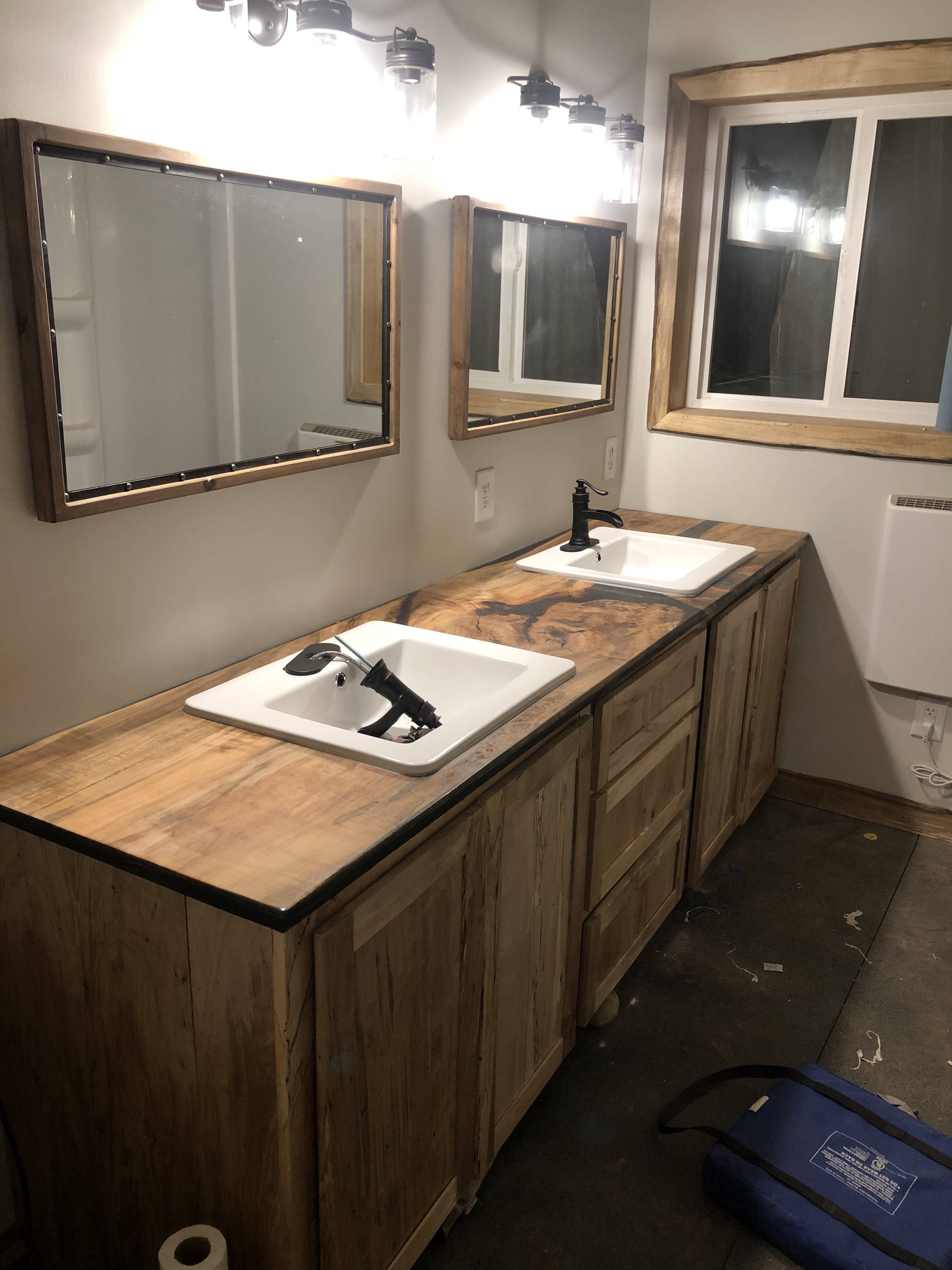 Custom built bathroom with dual sinks being installed
