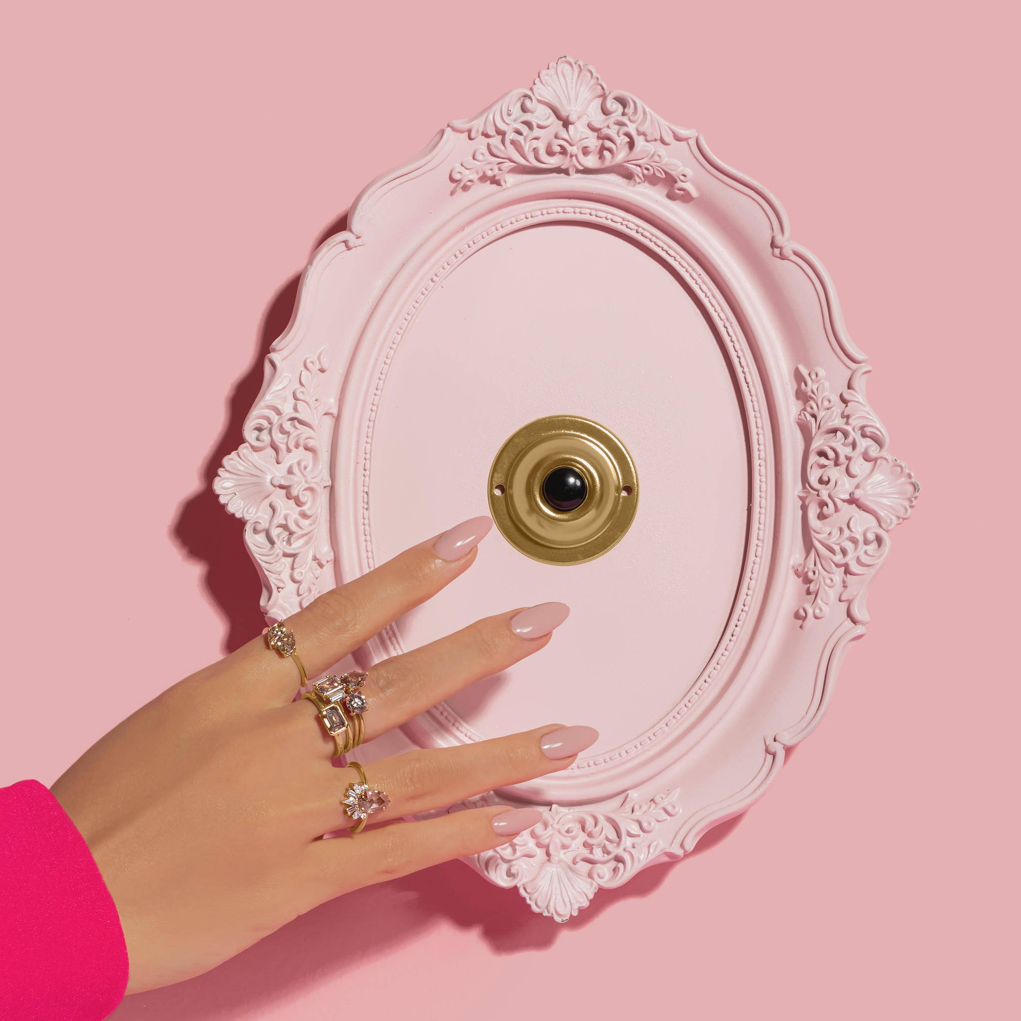 women pushing a doorbell wearing diamond rings