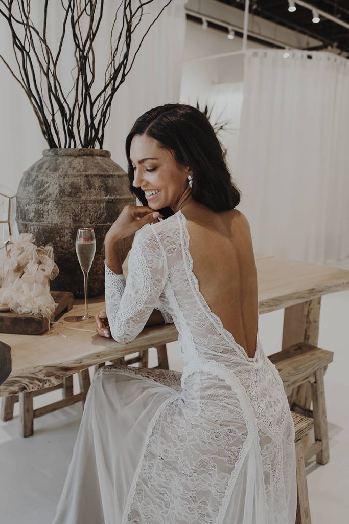 Bride wearing the Inca gown Inside the Grace Loves Lace Seattle bridal showroom