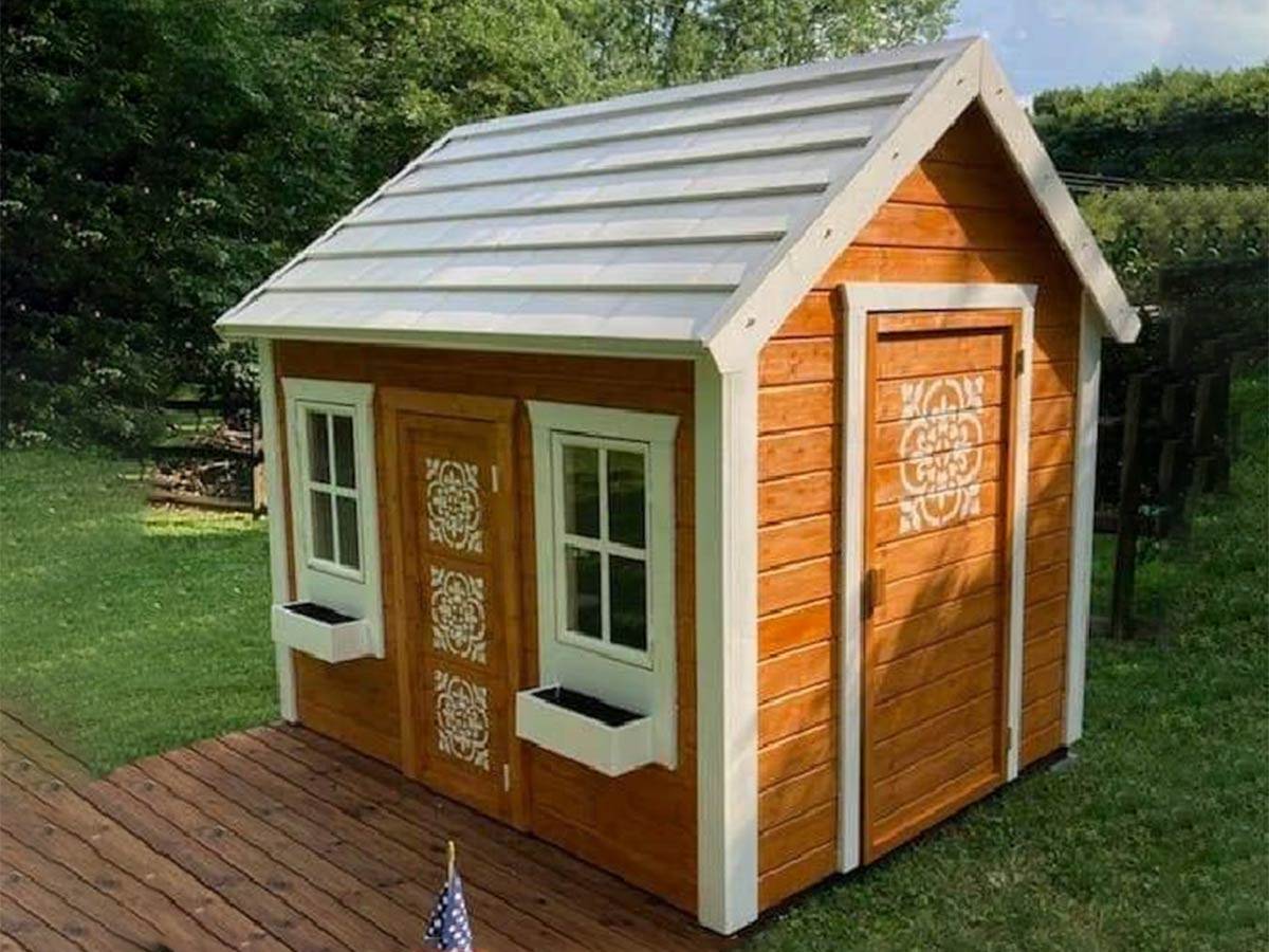 Kids Playhouse Natural Wonder in natural color with decorated doors by WholeWoodPlayhouses