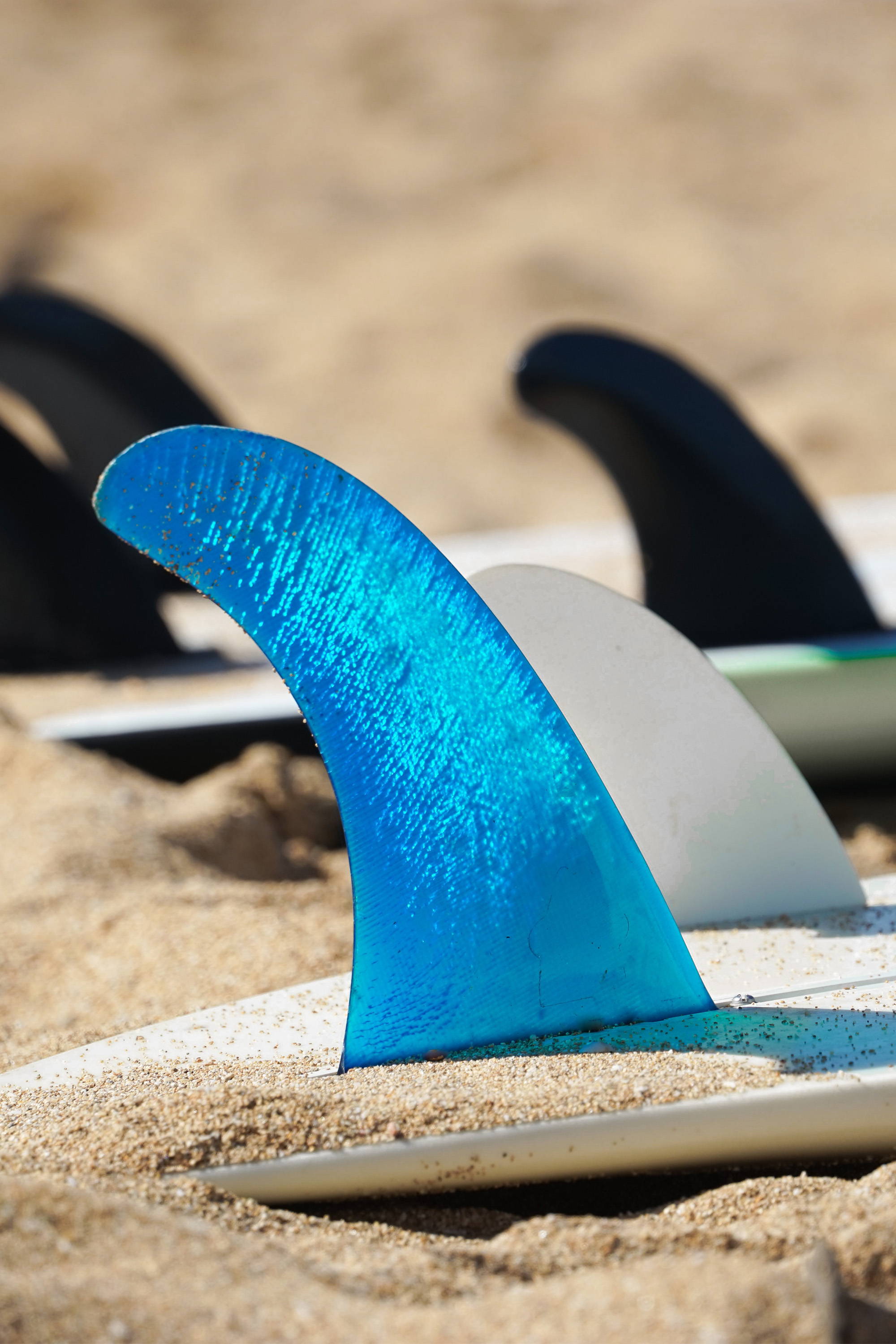 Surfboard Fins on surfboards on the beach
