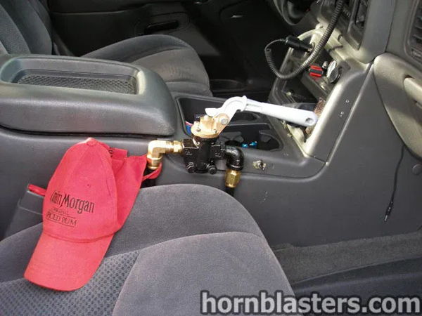 Interior close-up of the manual pull valve lever mounted beside the center console in Jerry's 2006 Chevy Silverado, install photo 11