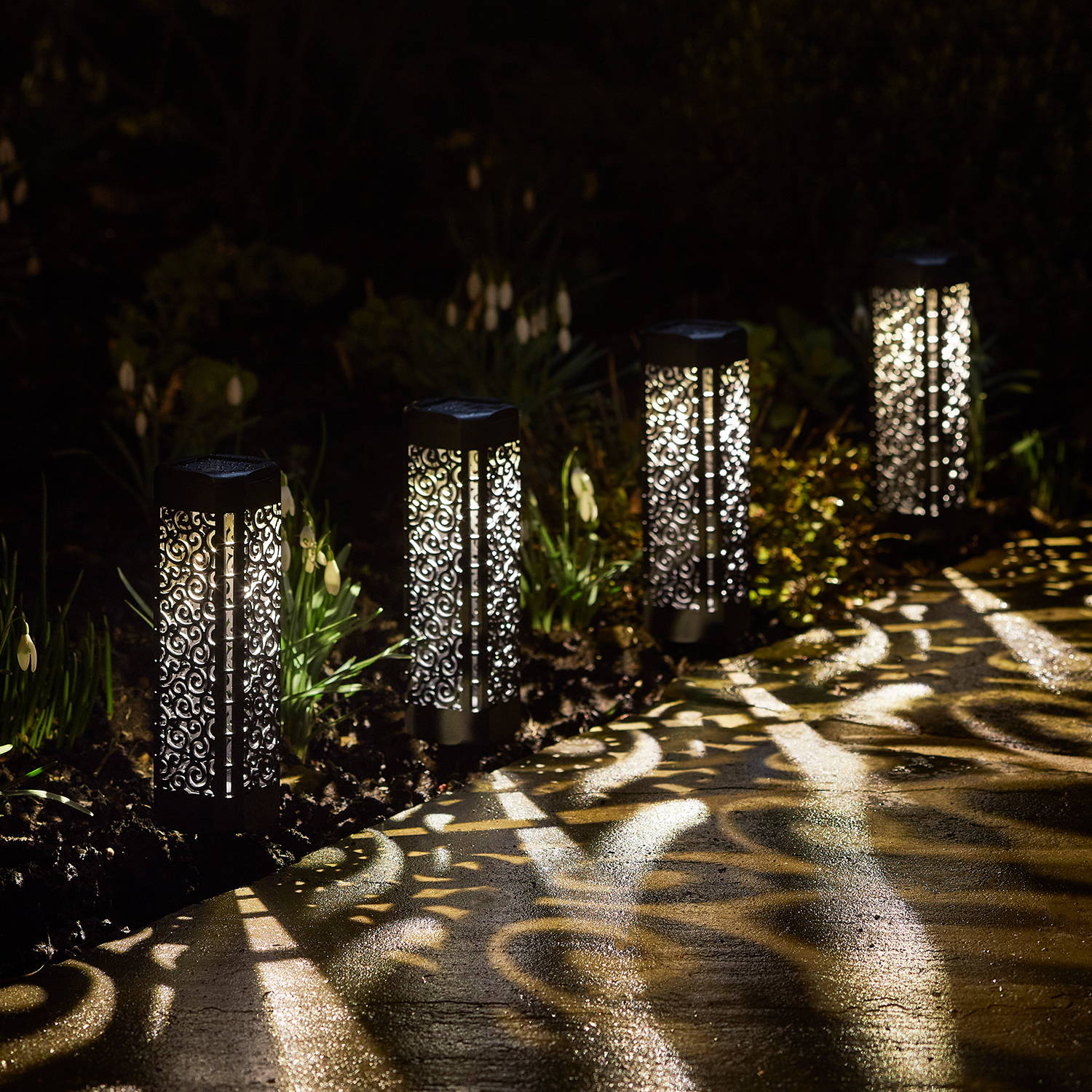 Moroccan stake lights, illuminating and shadowing the walkway outside