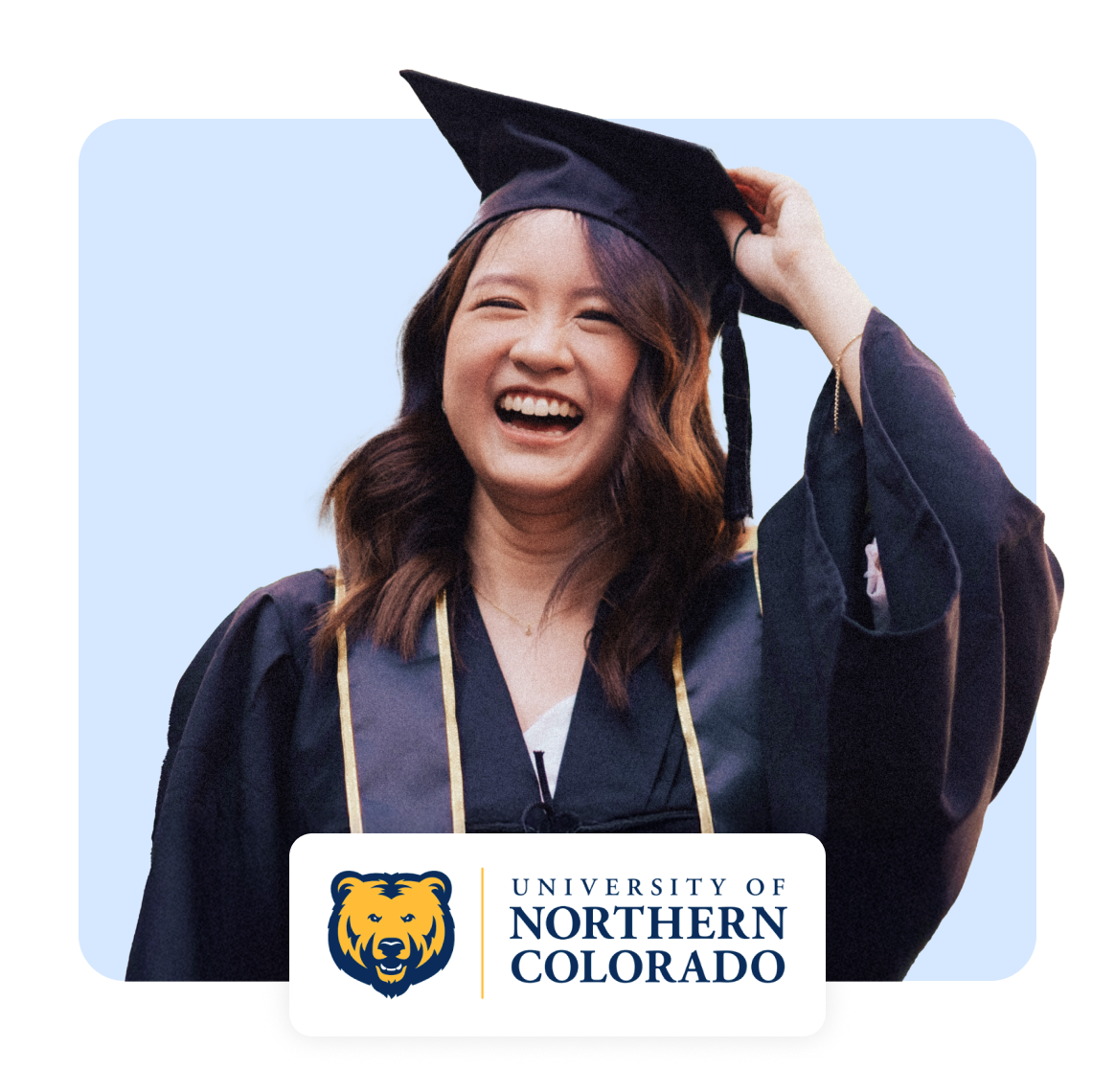 A smiling graduate in a cap and gown celebrating at University of Northern Colorado.