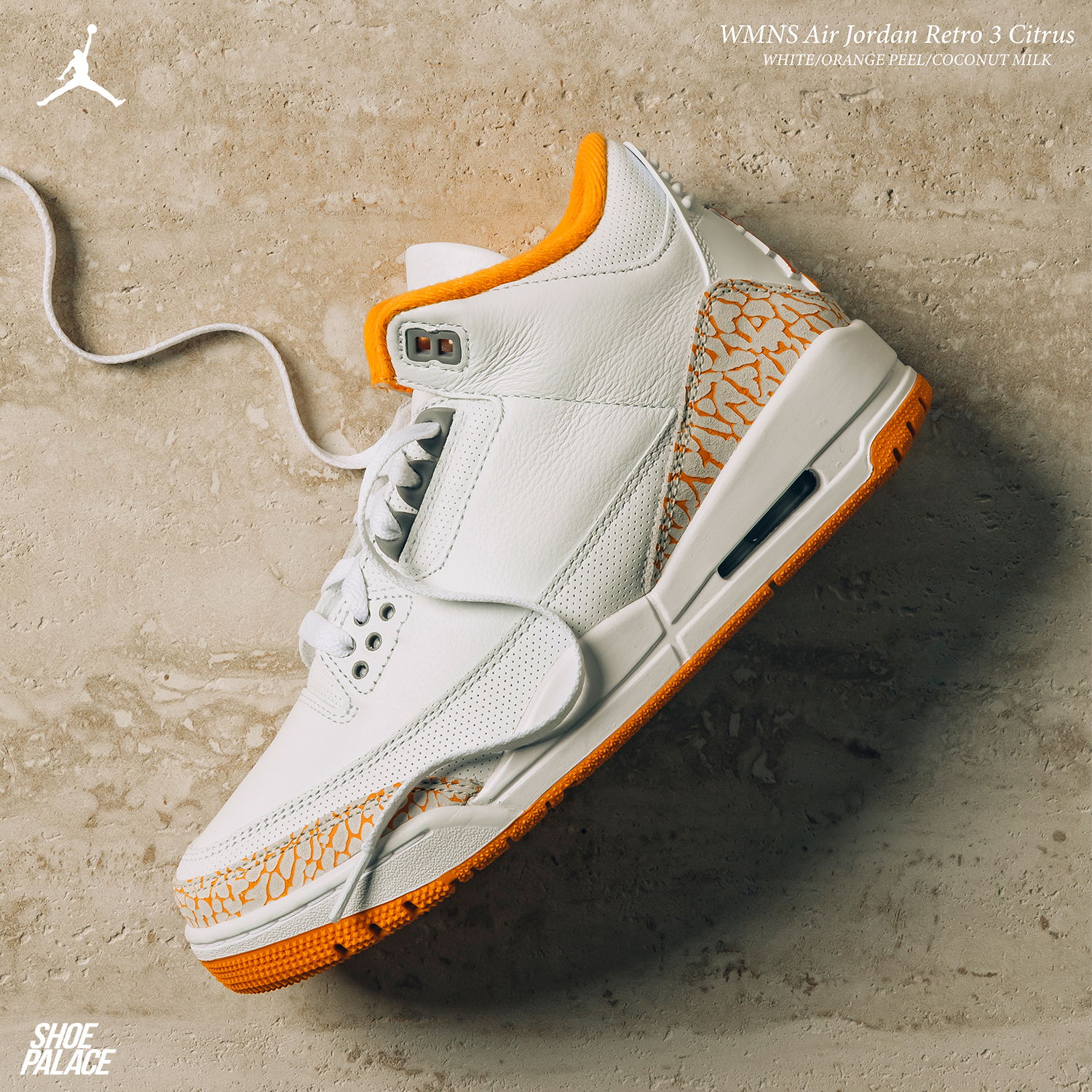 White and orange Air Jordan 3 sneaker on a textured background.