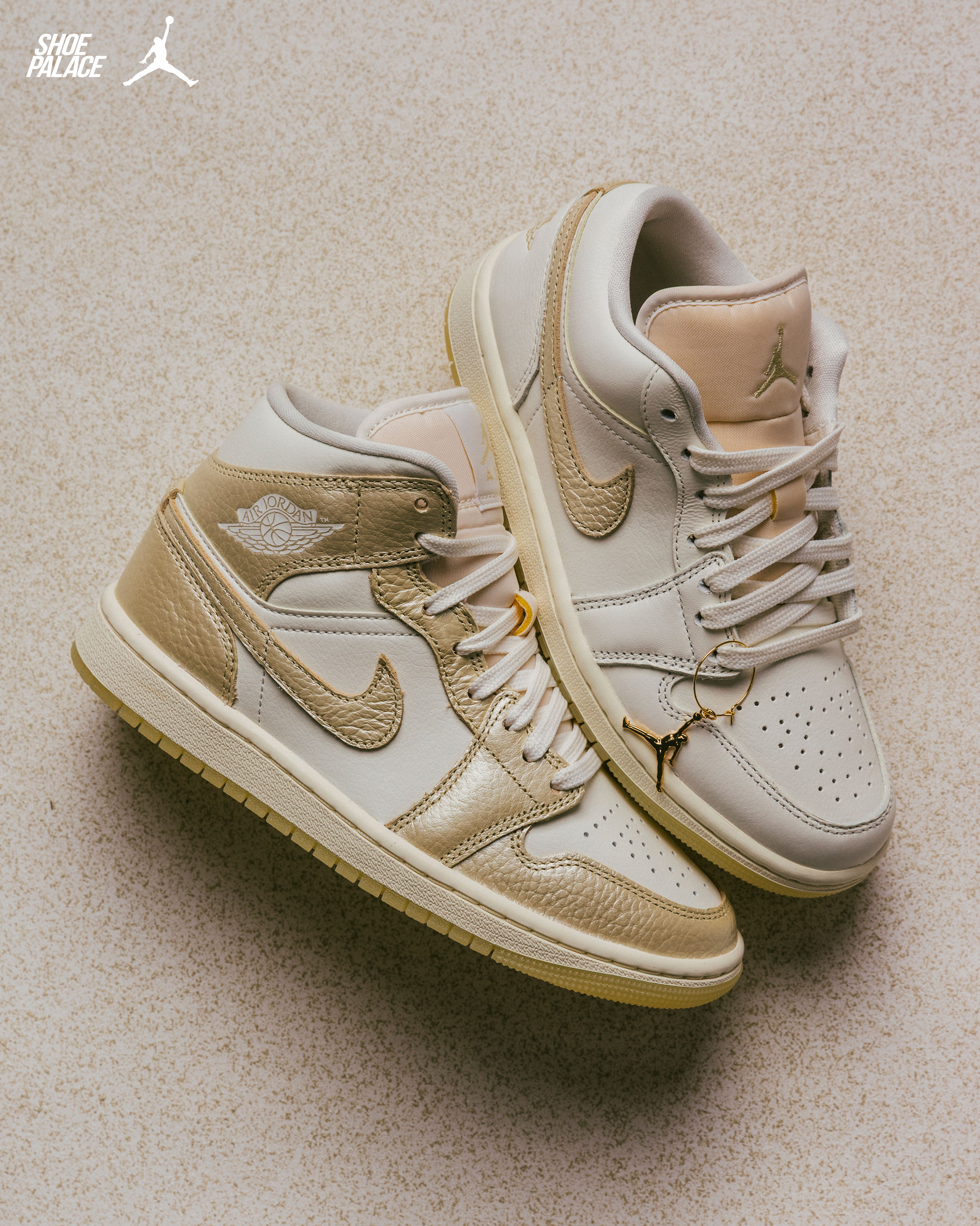 A pair of beige and white Air Jordan sneakers on a light background.