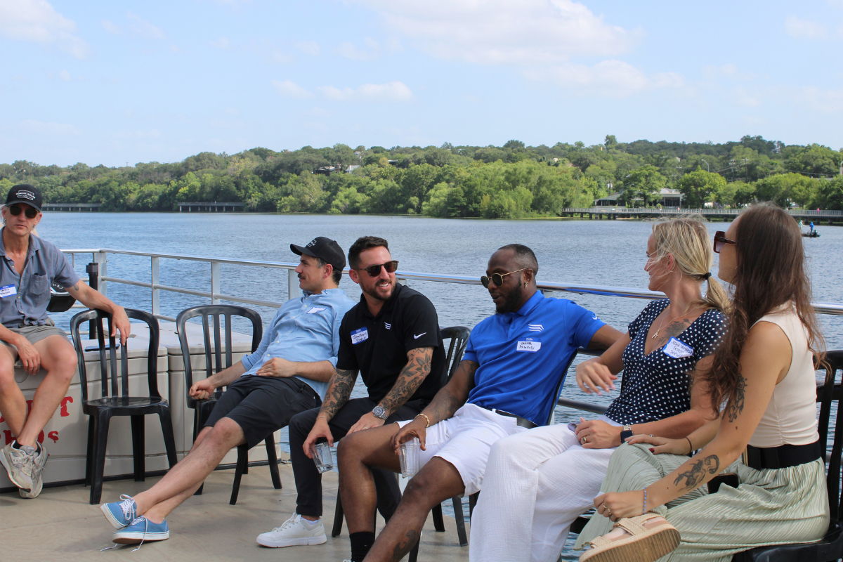 Group of solar installers and vendors having conversation on boat