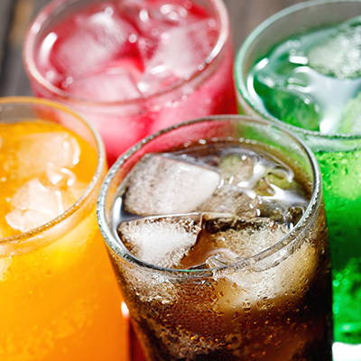 A photo showing four glasses of soda.