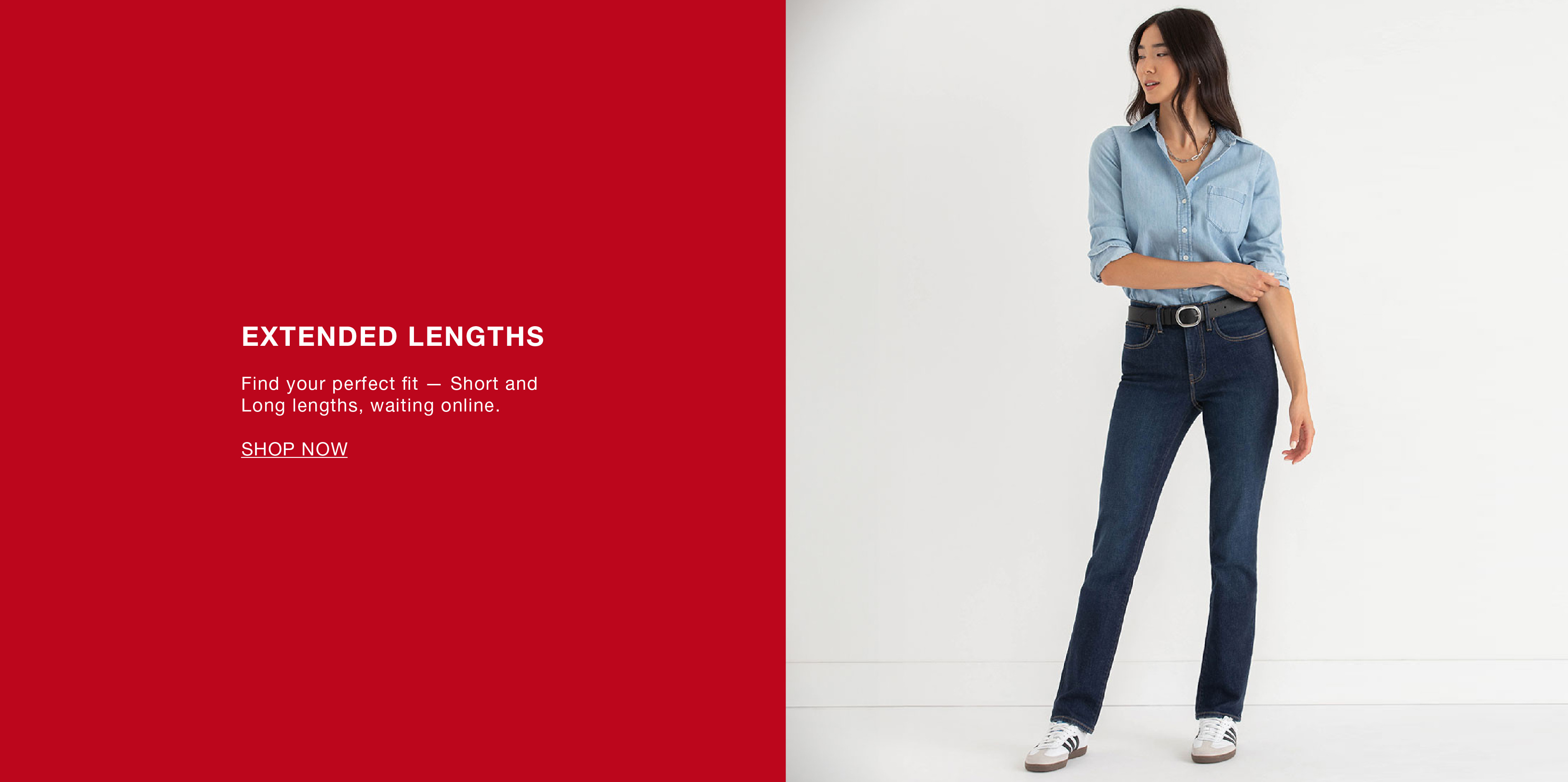 A woman in a blue shirt and dark jeans against a red background.