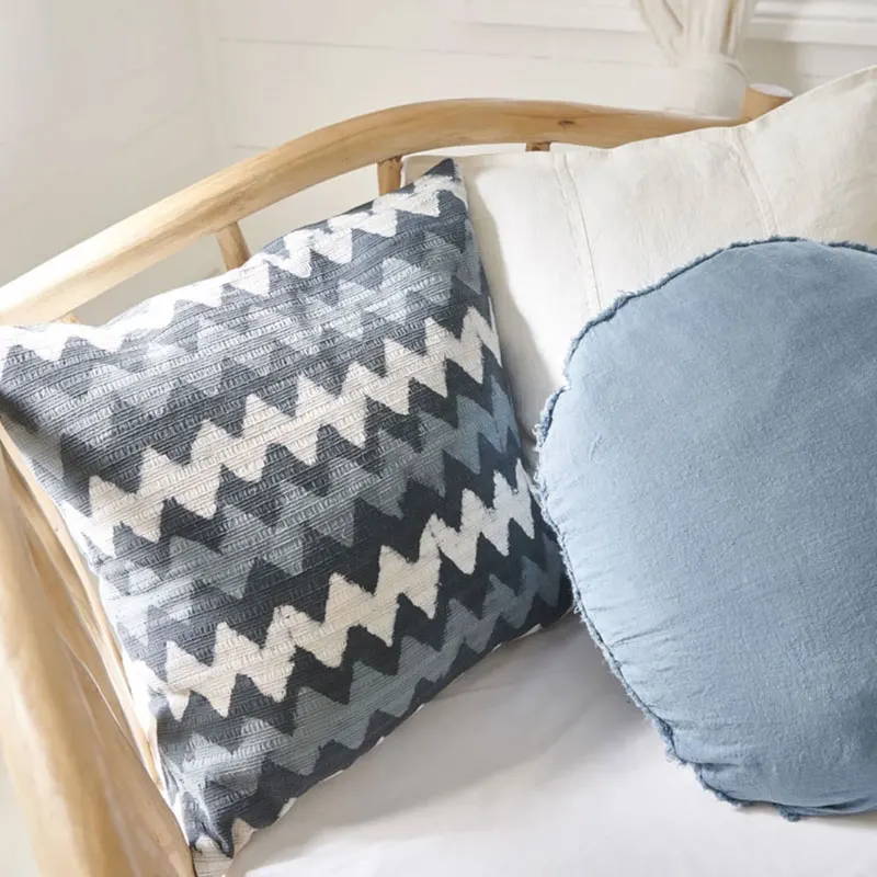 Blue linen cushions styled on a cane chair