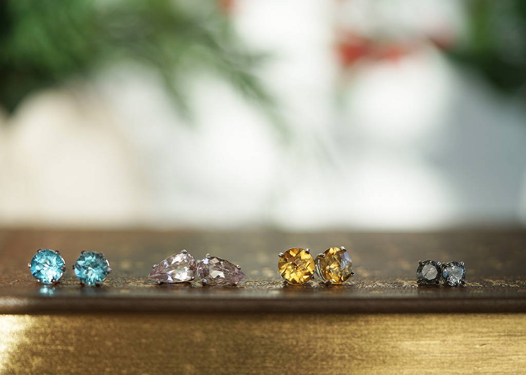 a collection of gemstone earrings in silver