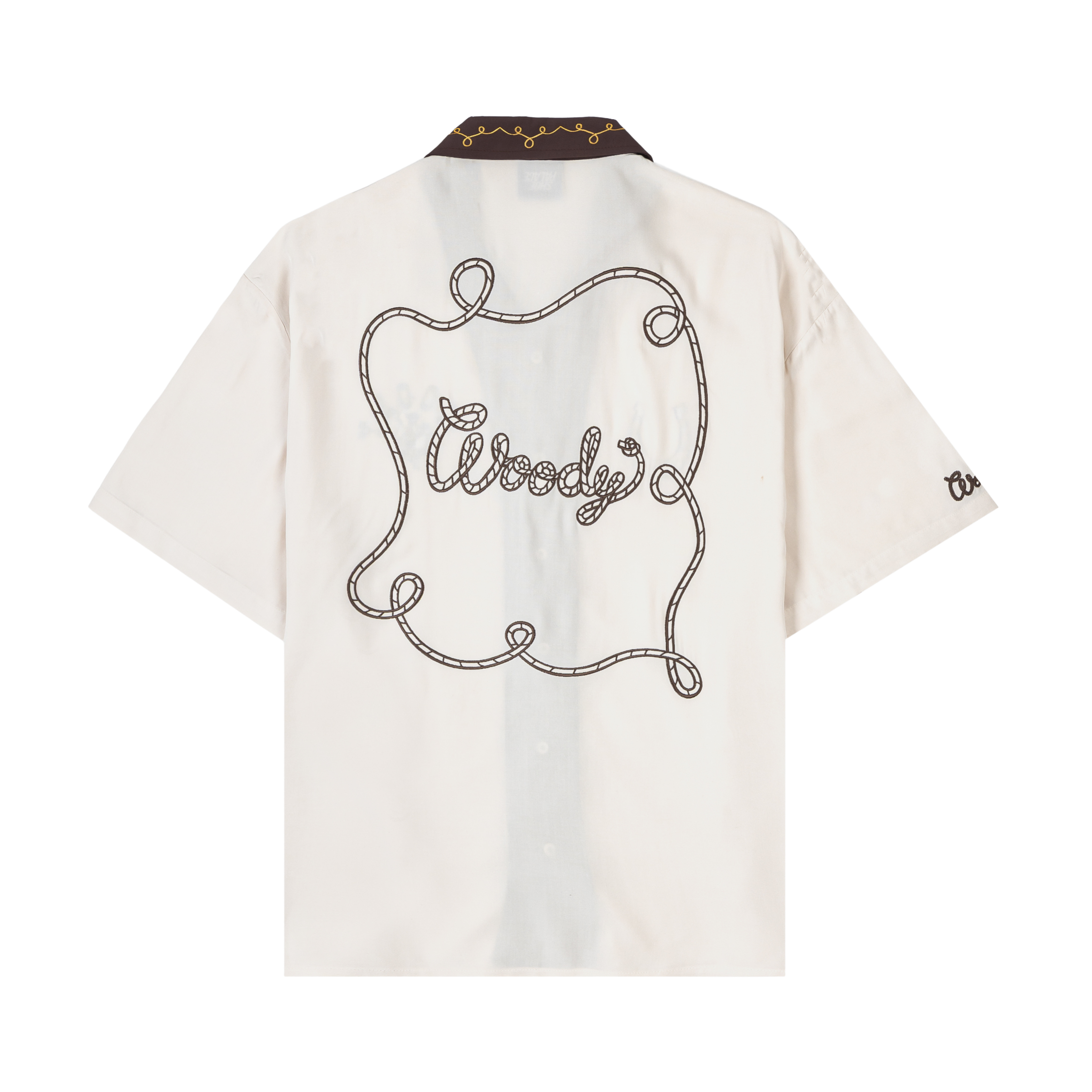 White short-sleeve shirt with embroidered designs and contrasting collar.