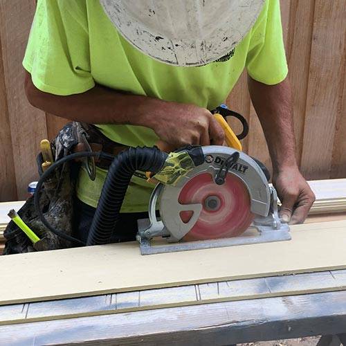 Worker Using A Table Saw Silica Dust Collection Hose