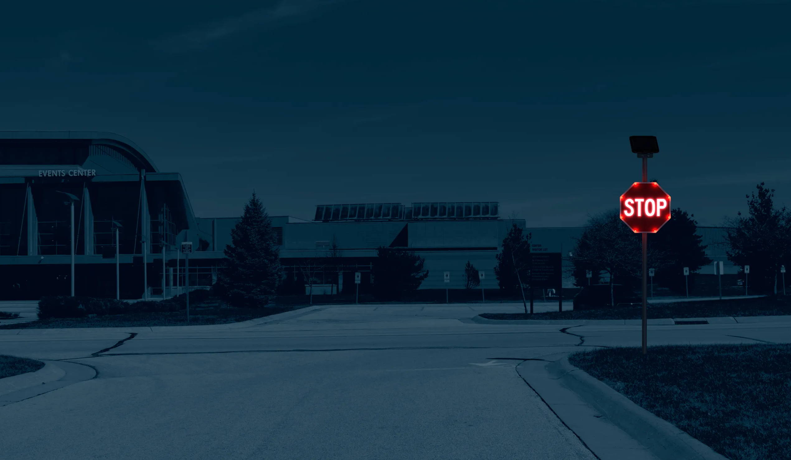 A flashing LED stop sign at an intersection.