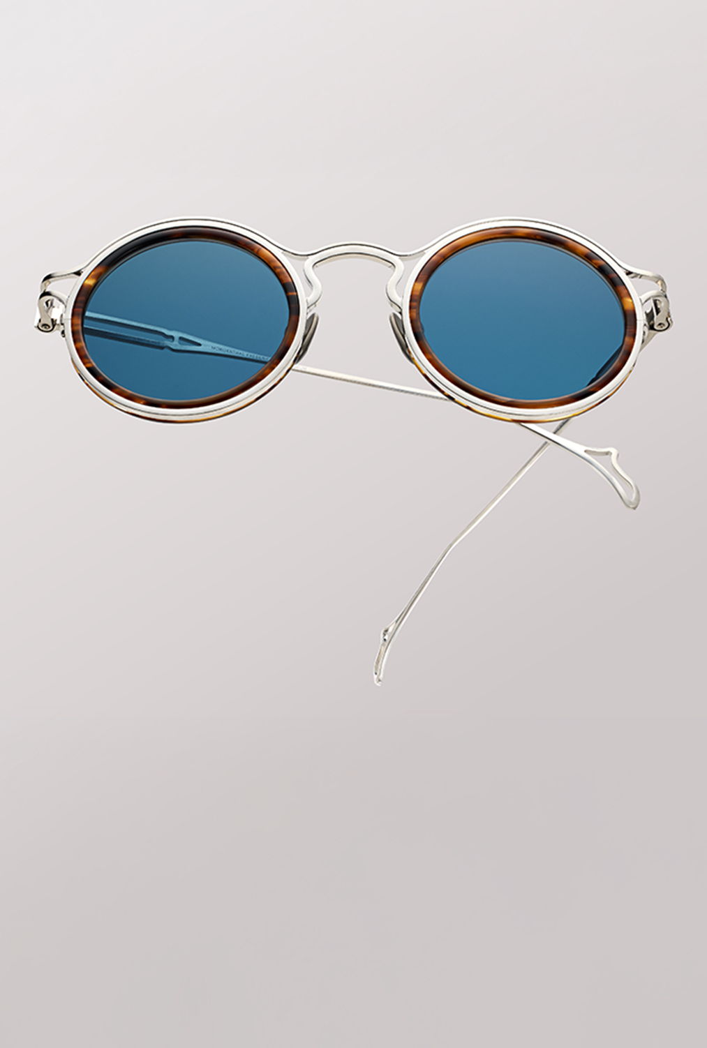 the ninety one sunglasses with blue lenses and a clear frame.
