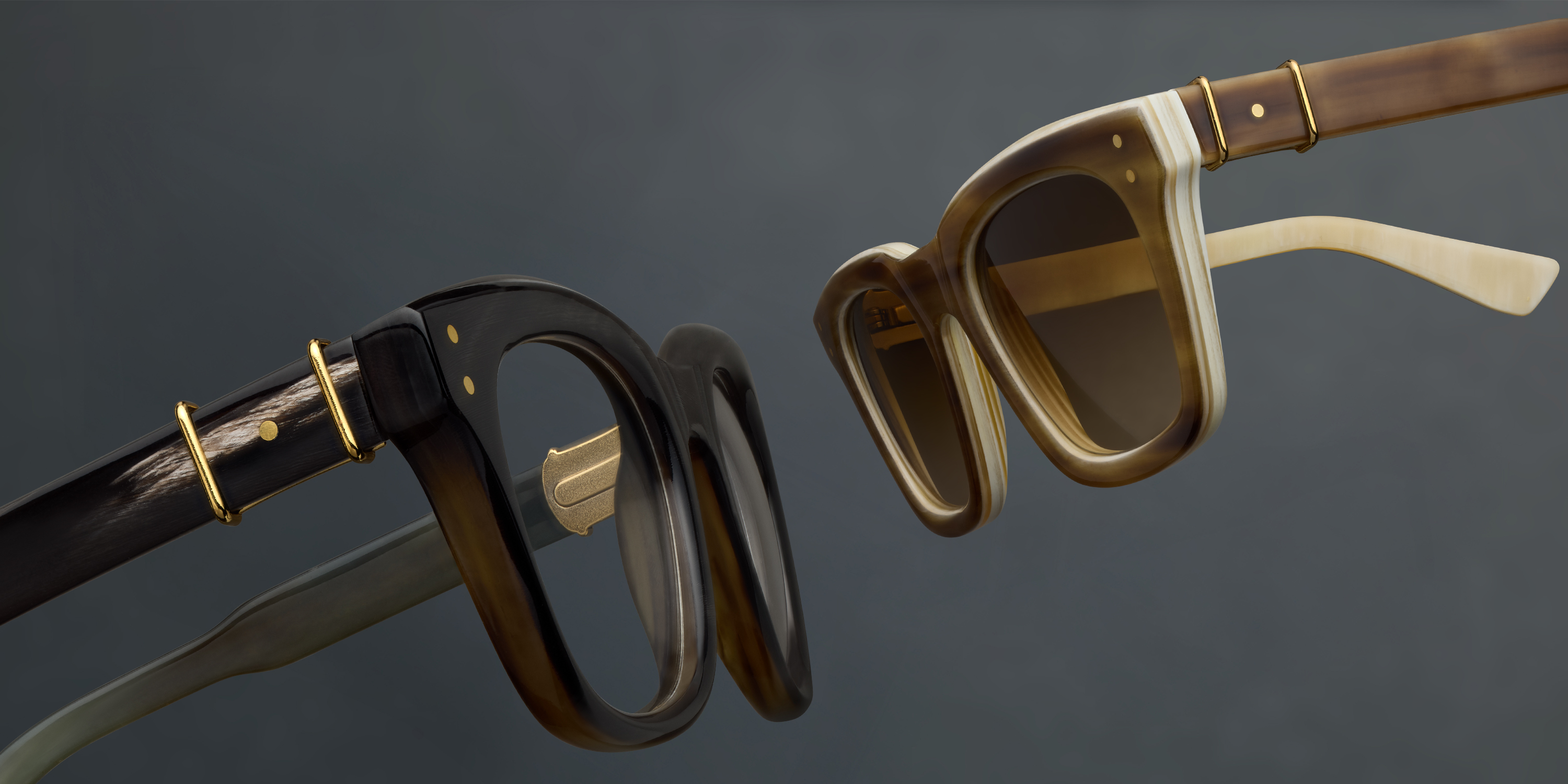 Two pairs of stylish Robert Marc sunglasses against a gray background.