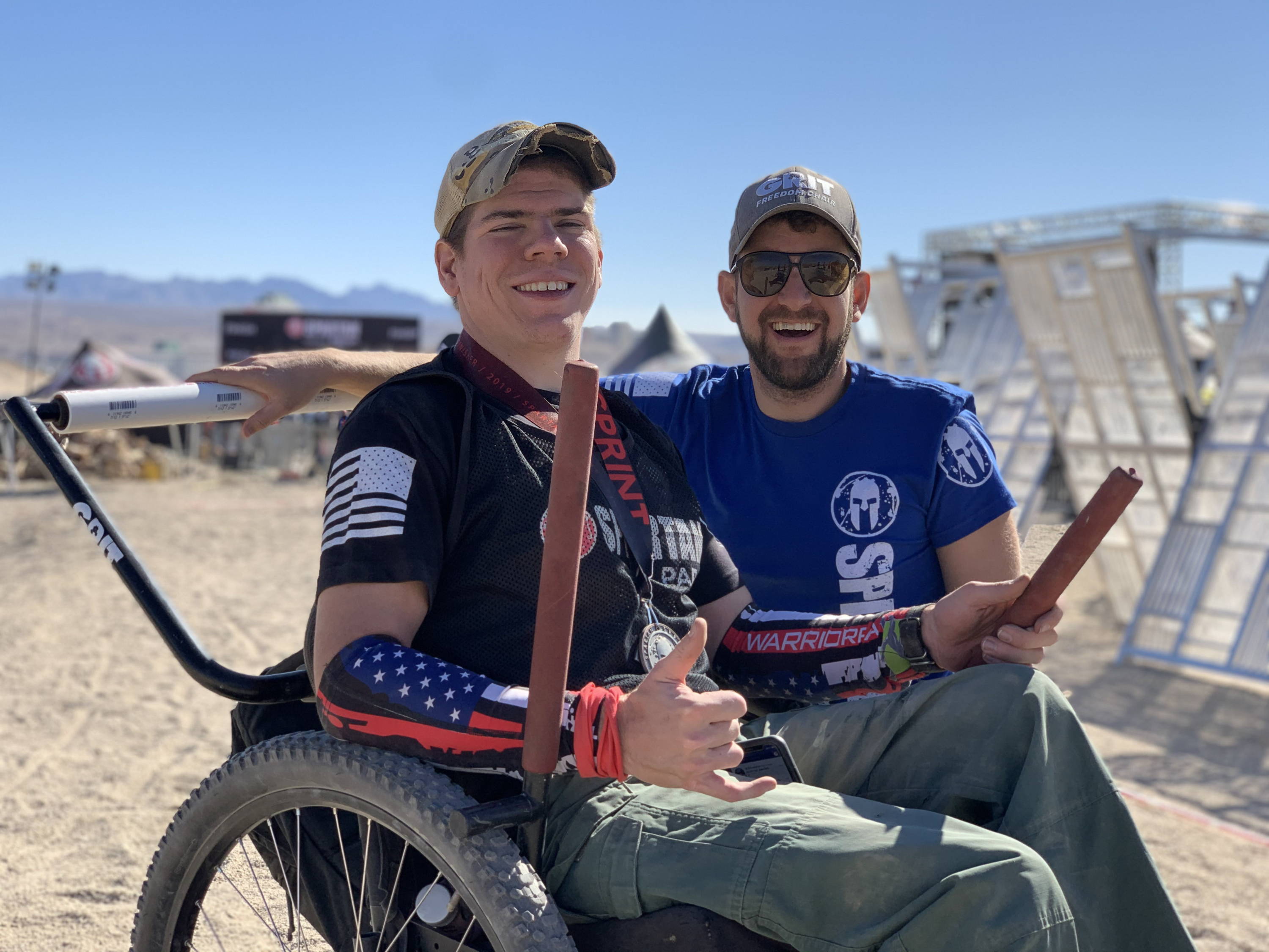 Tyler and Mike at Spartan Race outdoor obstacle course using all-terrain GRIT Freedom Chair