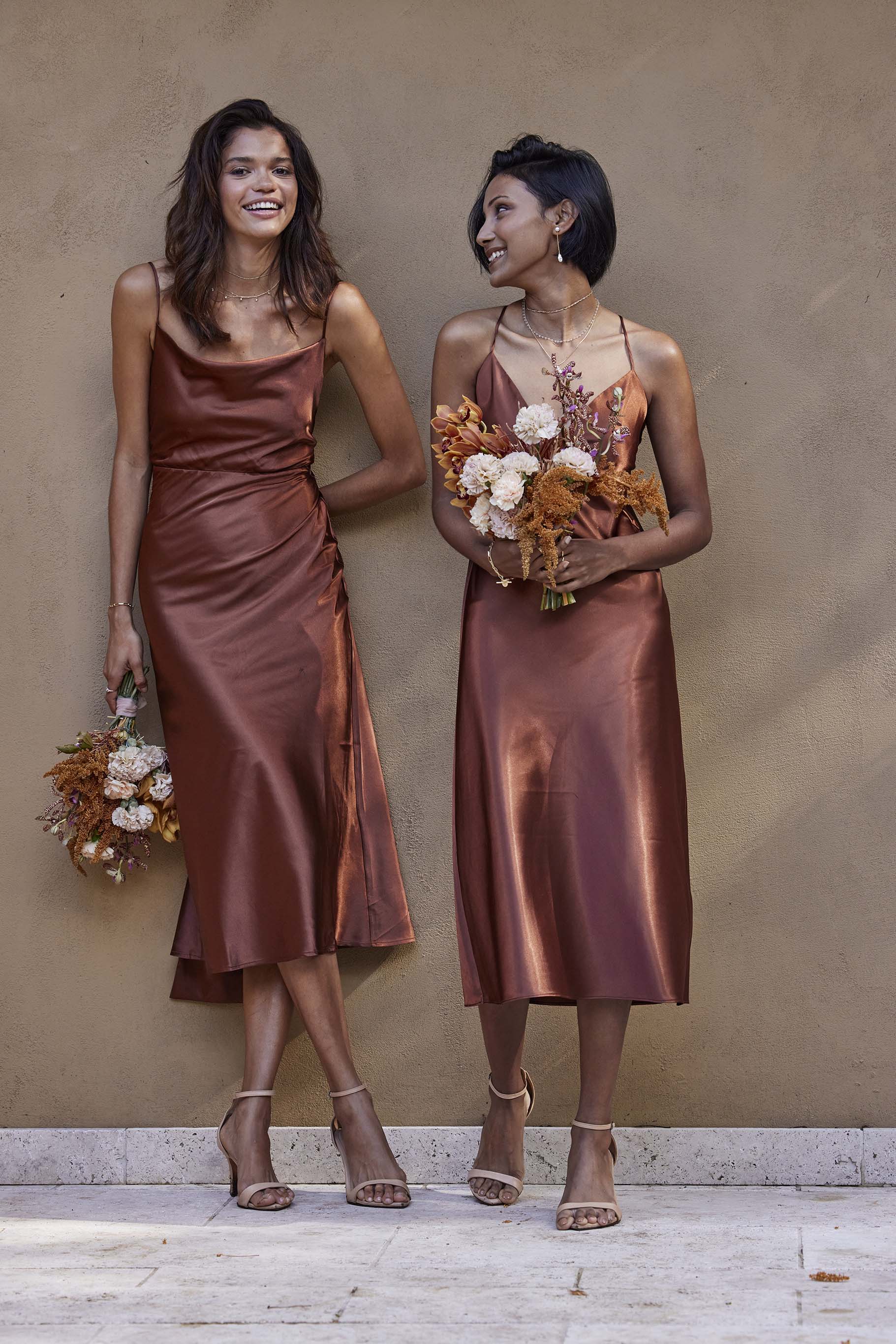 Bridesmaids holding bouquet in Grace Loves Lace Dresses