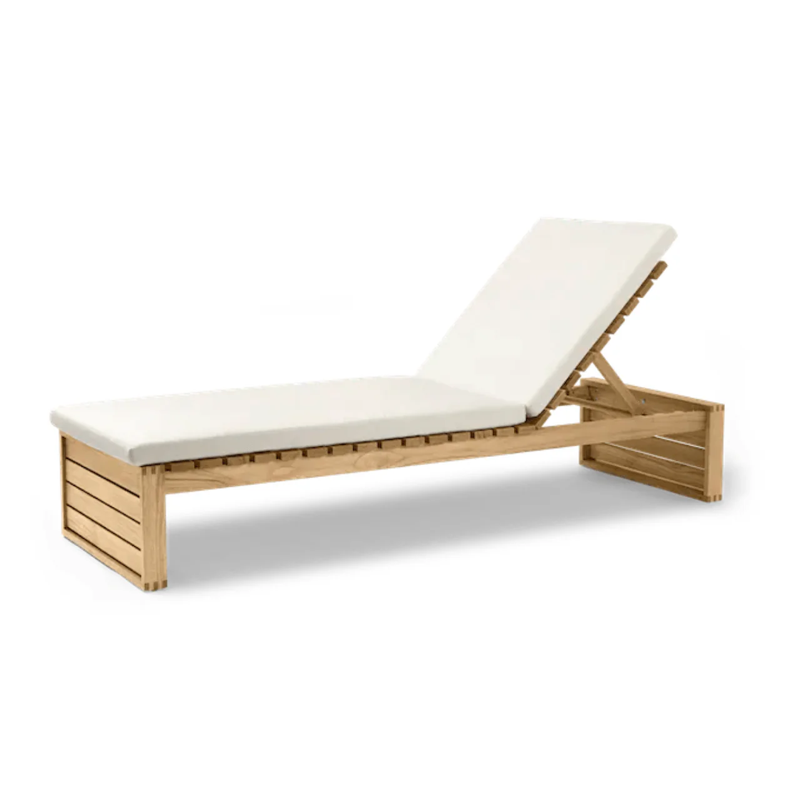 A Danish designed chaise lounger that is made of teak.