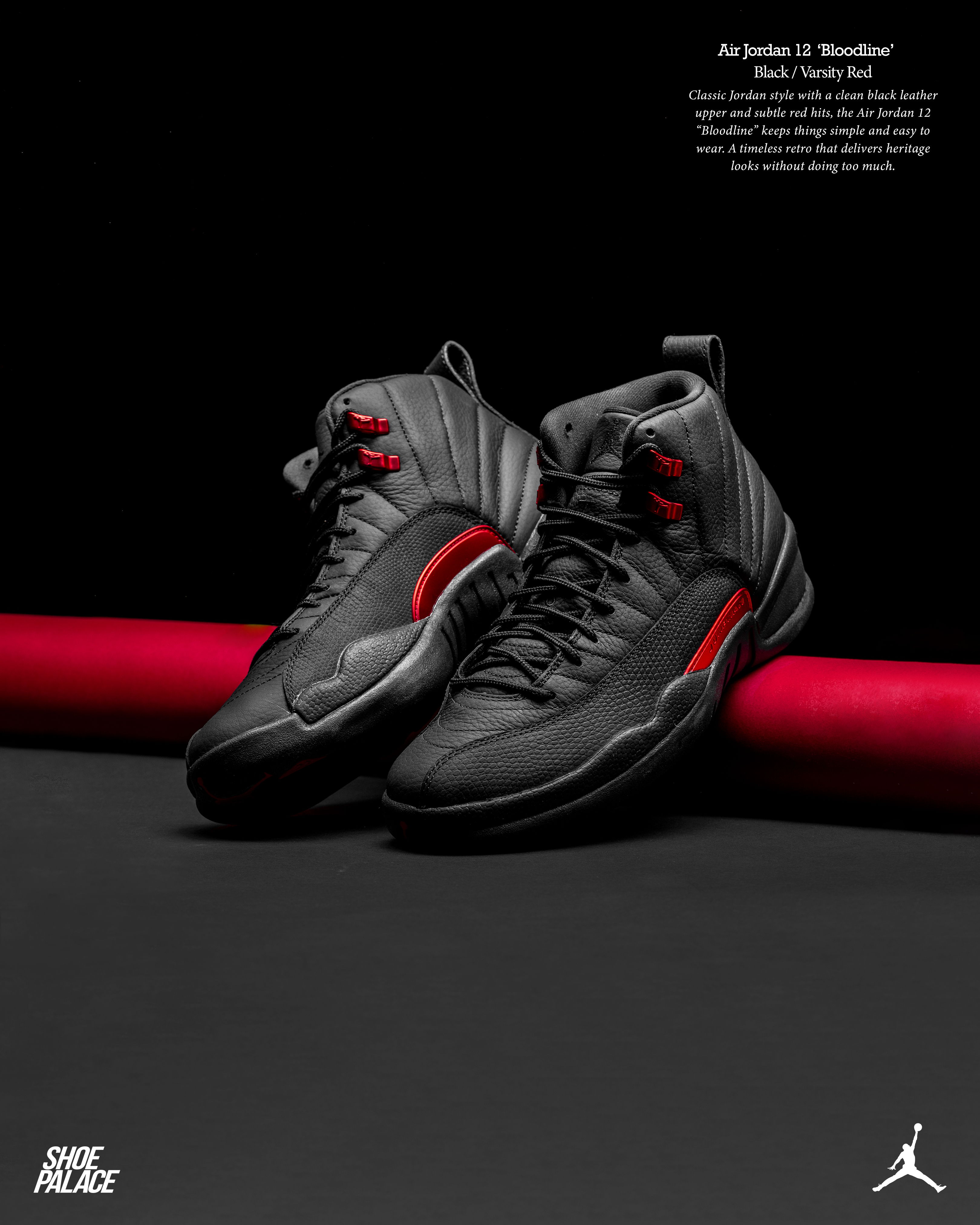 Black and red basketball sneakers on a dark surface.